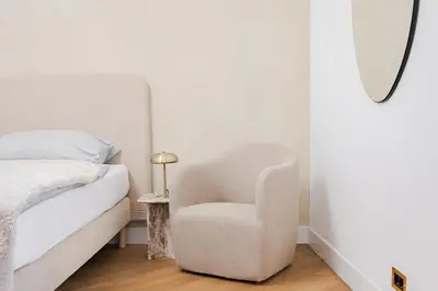 a bedroom with a bed and a chair and a mirror at LUXURY Apartman 2 min CHARLES BRIDGE in Prague