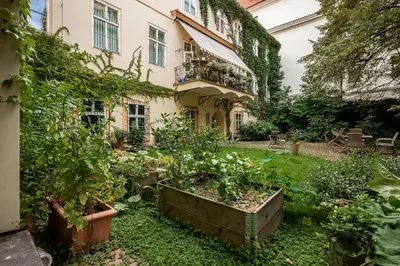 a garden in front of a building with plants at LUXURY Apartman 2 min CHARLES BRIDGE in Prague