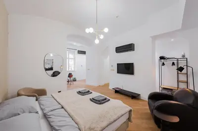 a living room with a couch and a table at LUXURY Apartman 2 min CHARLES BRIDGE in Prague
