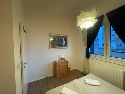 a bedroom with a bed and a window at 1Room in Family Apartment Barrandov in Prague