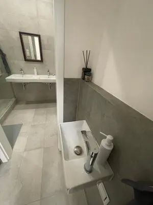 a white bathroom with a sink and a toilet at 1Room in Family Apartment Barrandov in Prague