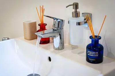 a bathroom sink with a faucet and toothbrushes at Luxury Urban Suite in Prague
