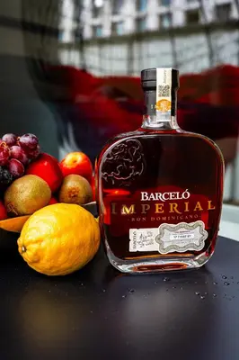 a bottle of bourbon next to a bowl of fruit at Luxury Urban Suite in Prague