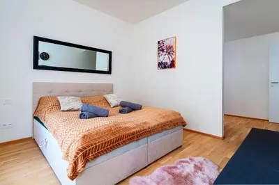 a bedroom with a bed with a mirror on the wall at Luxury Urban Suite in Prague
