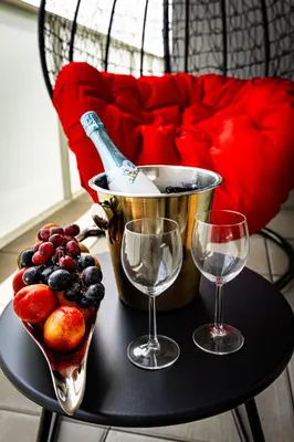 a table with two wine glasses and a bowl of fruit at Luxury Urban Suite in Prague