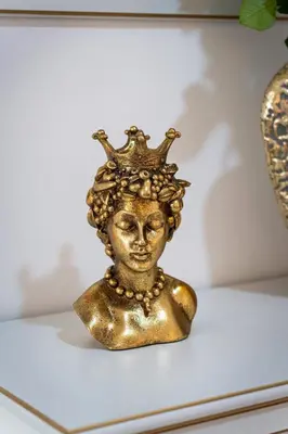 a gold bust of a woman wearing a crown at Crown of Leo in Prague