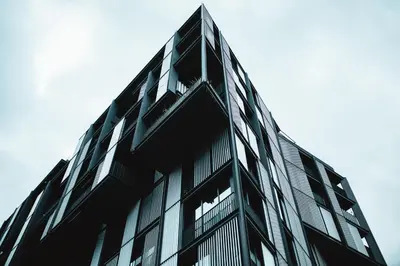 a black glass building with the sky in the background at Crown of Leo in Prague