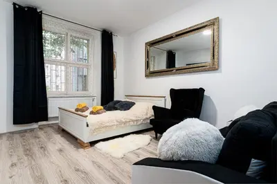 a bedroom with a bed and a mirror on the wall at Crown of Leo in Prague