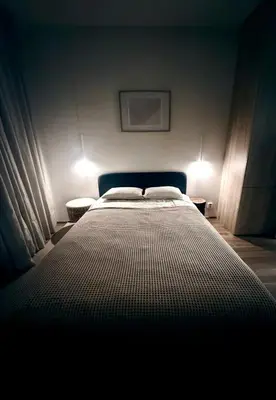 a bedroom with a bed and a wooden cabinet at Modern Studio near Letňany Expo in Prague