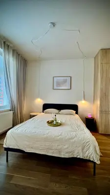 a bedroom with a large bed with a tray on it at Modern Studio near Letňany Expo in Prague