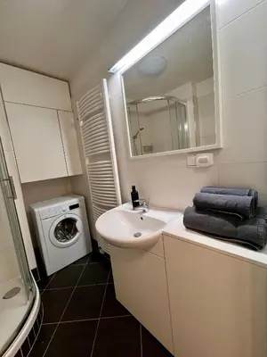 a bathroom with a sink and a washing machine at Modern Studio near Letňany Expo in Prague