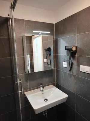 a bathroom with a sink and a mirror at Great Apartment Praha in Prague