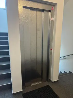 an elevator door in a building with stairs at Apartmán VBloku in Prague