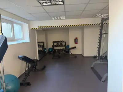 a gym with chairs and equipment in a room at Apartmán VBloku in Prague
