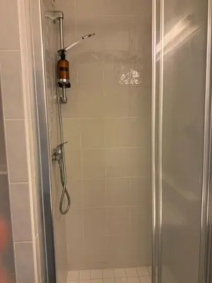 a shower with a glass door in a bathroom at Apartmán VBloku in Prague
