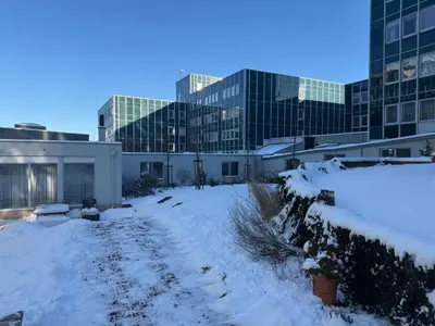 a yard covered in snow in front of buildings at Apartmán VBloku in Prague