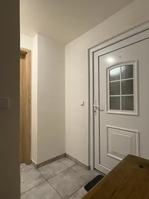 an empty room with a door and a window at Moderní podkrovní garsonka s hezkým výhledem in Prague
