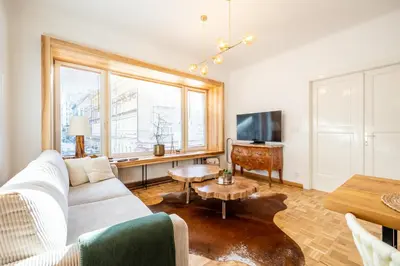a living room with a white couch and a table at Luxury Design Apartment Palackého Residence in Prague