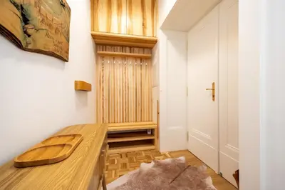 a home office with a wooden desk and a closet at Luxury Design Apartment Palackého Residence in Prague