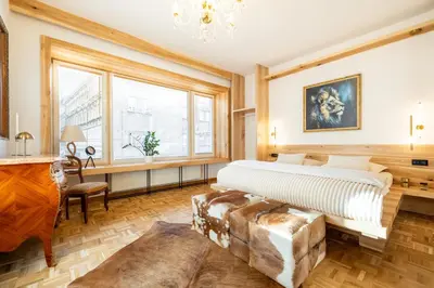 a bedroom with a king sized bed and a couch at Luxury Design Apartment Palackého Residence in Prague