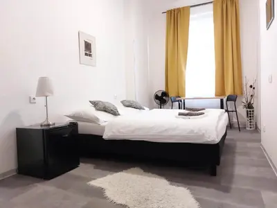 a bedroom with a large bed and a window at Boutique Hotel Milady H in Prague