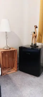 a lamp sitting on top of a television next to a table at Boutique Hotel Milady H in Prague