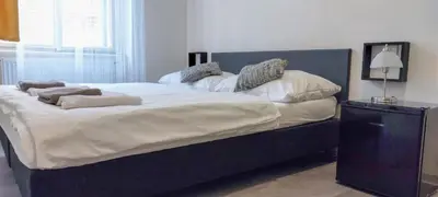 a bedroom with a large bed with white sheets and pillows at Boutique Hotel Milady H in Prague