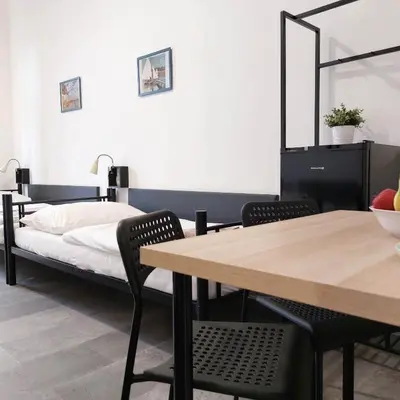 a bedroom with a bed and a table and chairs at Boutique Hotel Milady H in Prague