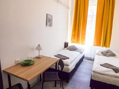 a room with a table and a bed and a desk at Boutique Hotel Milady H in Prague