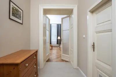 a hallway with a wooden dresser and a door at Charming home near Old Town and Central Station in Prague