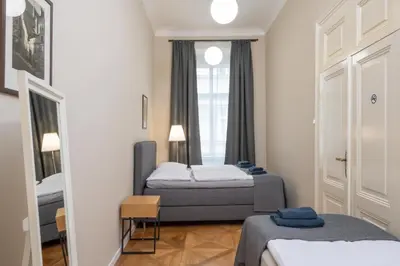 a hotel room with two beds and a window at Charming home near Old Town and Central Station in Prague