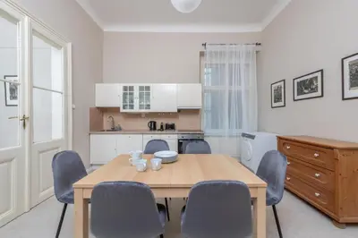 a kitchen and dining room with a wooden table and chairs at Charming home near Old Town and Central Station in Prague