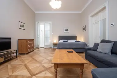 a living room with a couch and a bed and a table at Charming home near Old Town and Central Station in Prague