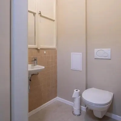 a small bathroom with a toilet and a sink at Charming home near Old Town and Central Station in Prague