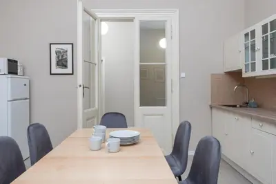 a kitchen with a wooden table and chairs in a kitchen at Charming home near Old Town and Central Station in Prague