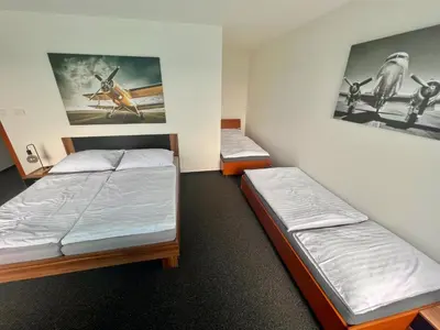a room with two beds in a room at Hotel CAVOK letiště Příbram in Drásov