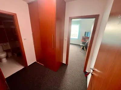 a room with a bathroom with a toilet and a door at Hotel CAVOK letiště Příbram in Drásov