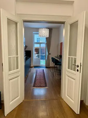 an open door into a living room with a table at Duplex Design Flat 3 Bäder Garten 160 m2 in Prague
