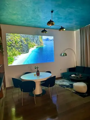 a living room with a table and a painting on the wall at Duplex Design Flat 3 Bäder Garten 160 m2 in Prague
