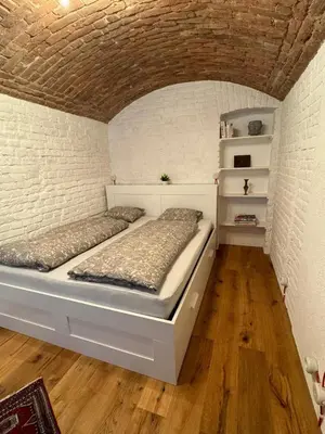 a bedroom with two beds and a brick wall at Duplex Design Flat 3 Bäder Garten 160 m2 in Prague