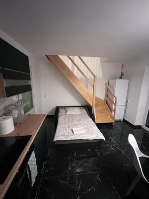 a room with a bed and a staircase in it at ZANIK Cozy Haven in Prague