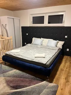a bed in a bedroom with a black headboard at ZANIK Cozy Haven in Prague
