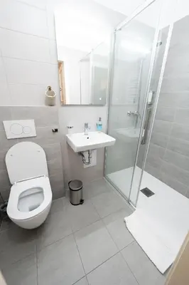 a bathroom with a toilet and a sink and a shower at Zámek v Kostelci nad Černými lesy in Kostelec nad Černými Lesy