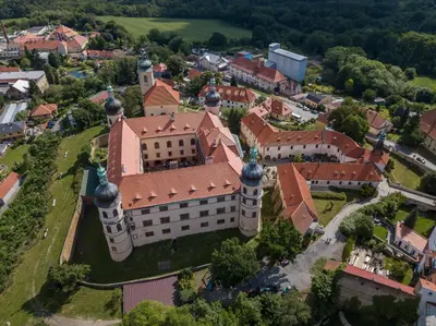 an overhead view of a large building with turrets at Zámek v Kostelci nad Černými lesy in Kostelec nad Černými Lesy