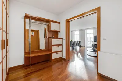 a living room with a dresser and a mirror at Skyline 127m Residence with Terrace - Prague Castle View in Prague