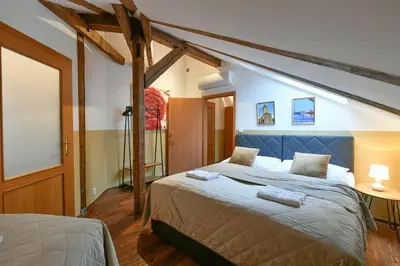 a bedroom with a bed with two towels on it at Amazing Charles Bridge Apartment in Prague