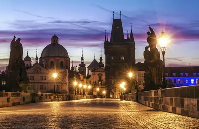 a view of a city at night at Amazing Charles Bridge Apartment in Prague