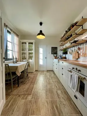 a kitchen with a table and a dining room at Honey Gardens venkovský apartmán v přírodní zahradě in Oleška