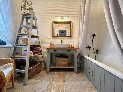 a bathroom with a ladder and a sink and a mirror at Honey Gardens venkovský apartmán v přírodní zahradě in Oleška