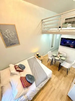 a bedroom with a large bed and a dining room at Cozy museum view studio 104 in Prague